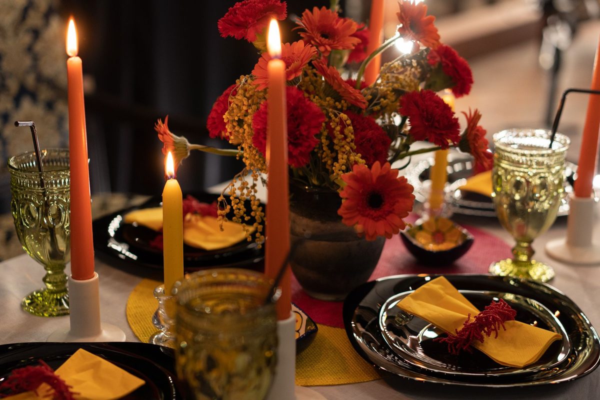 Intimate candlelit dinner party prepared for a casino-themed celebration
